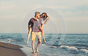 Happy couple in love on beach summer vacations.