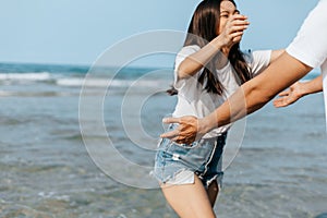 Happy couple in love on the beach. Woman running into men`s embrace on the beach