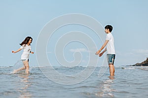 Happy couple in love on the beach. Woman running into men`s embrace on the beach