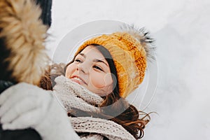 The happy couple in love at forest nature park in cold season. Happy brunette girl in yellow hat. Travel adventure love story