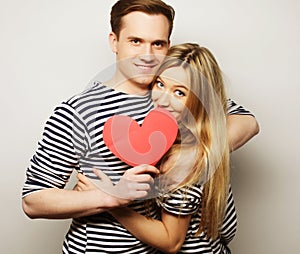 Happy couple in love holding red heart