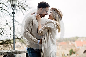 Happy couple in love hugging and smiling outdoor