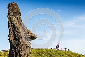 Happy couple in love and Moai statues in the Rano Raraku Volcano