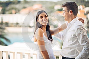 Happy couple in love on a summer holiday vacation.Celebrating holiday,anniversary,engagement. Woman laughing at a joke