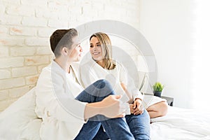 Happy Couple In Love Talking On Bed