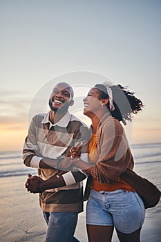 Happy couple, love and travel at the beach holding hands on date, quality time and romance at sunset. Black woman and