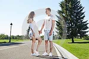 Happy couple in love waiting for child pregnancy hug walk in the summer park green trees nature husband and wife baby boy young