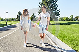 Happy couple in love waiting for child pregnancy hug walk in the summer park green trees nature husband and wife baby boy young