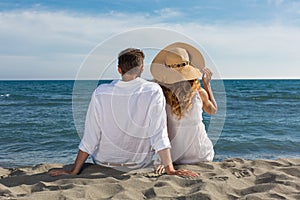 Happy couple in love walking on the beach