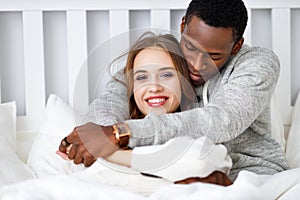 Happy couple in love on winter morning in bed