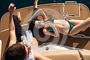 Happy couple lying on a boat at sea. Luxury vacation on a yacht in the islands.