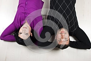 Happy couple lying down on floor