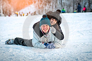 Happy couple lying in the snow