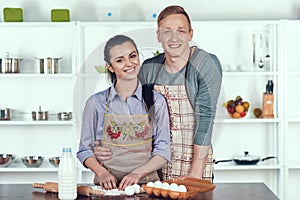 Happy Couple Making Domestic Pastry at Kitchen.