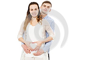 Happy couple making a heart shape on the pregnant belly with their hands. Concept of pregnancy, expecting a baby, love, care photo
