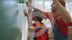 Happy couple making house renovation indoors. Cheerful family having fun.