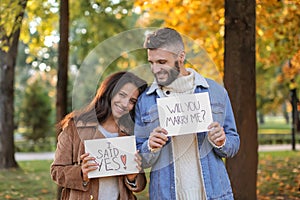Happy couple after making proposal in autumn park
