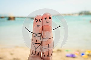 Happy couple. Man and woman have a rest on the beach in bathing suits.