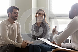 Happy couple, man and woman at reception with family therapist.