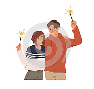 Happy couple of man and woman with sparklers in hands, celebrate Christmas holiday. People holding festive fireworks