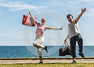 Happy couple man and woman with sport bags.