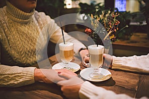 Happy Couple Meeting And Drinking Coffee. love and romantic date in downtown cafe restaurant. Young happy couple in love