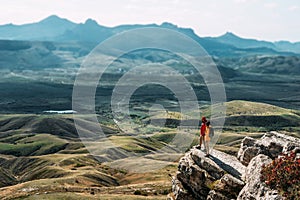 A happy couple in the mountains admires the beautiful views.