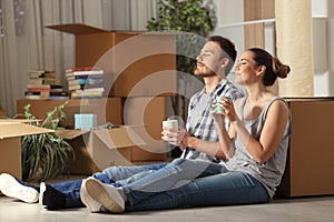 Happy couple moving home resting breathing fresh air