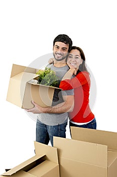 Happy couple moving together in a new house unpacking cardboard boxes