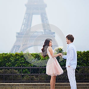 Happy couple near the Eiffel tower