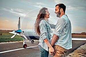 Happy couple near private plane