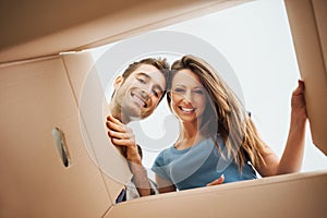 Happy couple opening a box