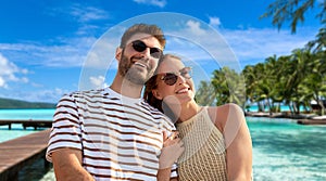 happy couple over tropical beach background