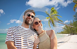 happy couple over tropical beach background