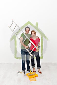 Happy couple painting their home