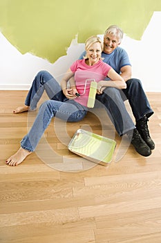 Happy couple with painting utensils.