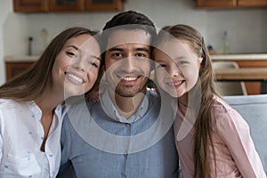 Happy couple of parents and daughter child head shot portrait