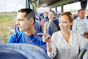 Happy couple or passengers in travel bus