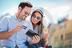 Happy couple paying on line with credit card and digital tablet photo