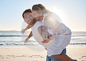 Happy, couple and piggyback walk on the beach for love, travel or summer vacation bonding together in the outdoors. Man