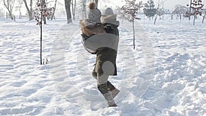 Happy couple play together during winter holidays vocation outside in snow park