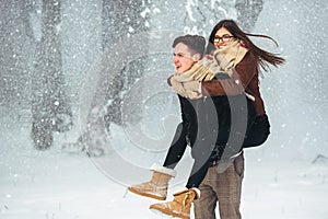 Happy couple playful together in snow park