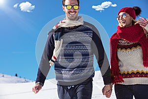 Happy couple playful together during winter holidays vacation outside in snow park