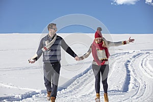 Happy couple playful together during winter holidays vacation outside in snow park