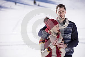 Happy couple playful together during winter holidays vacation outside in snow park