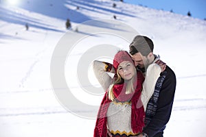 Happy couple playful together during winter holidays vacation outside in snow park