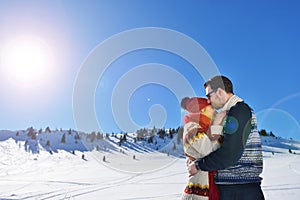 Happy couple playful together during winter holidays vacation outside in snow park