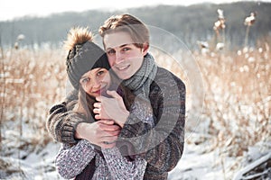 Happy couple playful together during winter holidays vacation outside in snow park