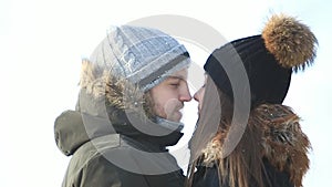 Happy couple playful together during winter holidays vocation outside in snow park