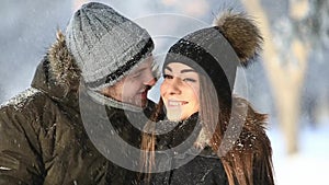 Happy couple playful together during winter holidays vocation outside in snow park. close up view